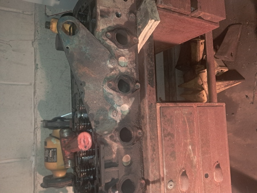 Diesel engine cylinder head block removed and placed on a workbench during engine rebuild