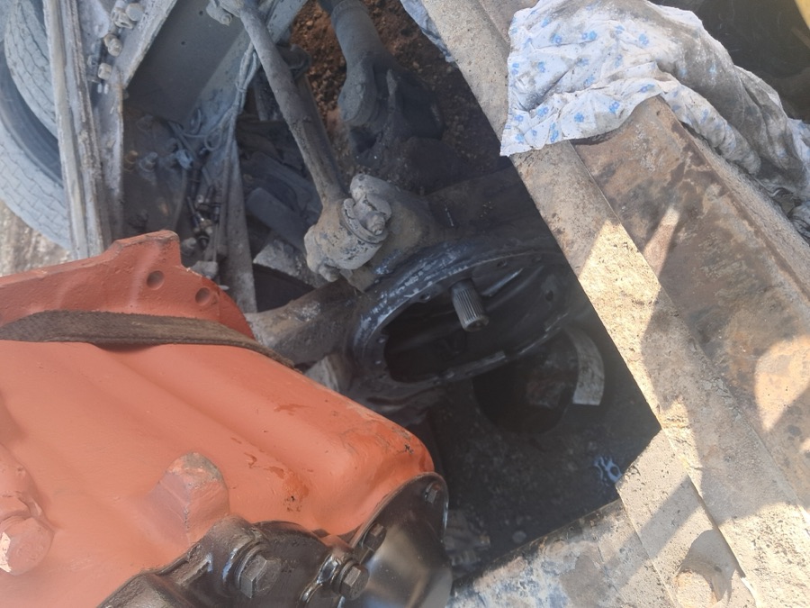 Truck rear axle and differential housing components laid out during suspension and drivetrain repair